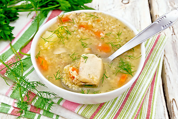 Image showing Soup fish with millet and spoon on light board