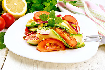 Image showing Salad with zucchini and tomato on light board