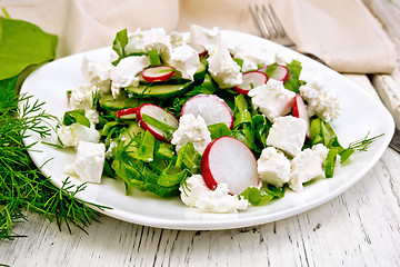 Image showing Salad with cheese and radishes in plate on board