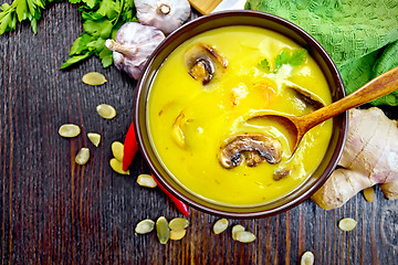 Image showing Soup-puree pumpkin with champignons and shrimps on board top