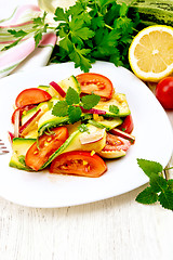 Image showing Salad with zucchini and tomato in plate on board