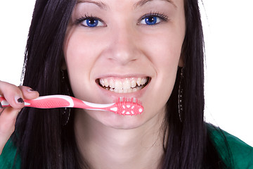 Image showing Close up of a beautiful woman brushing her teeth 