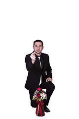 Image showing Businessman with Flowers and a Ring Proposing
