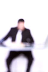 Image showing Blurry Background of a Businessman at His Desk Working