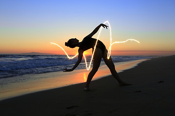 Image showing Skilled Young Dancer at the Beach During Sunset