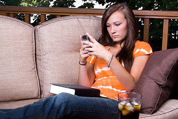 Image showing Beautiful Girl  Texting in the Patio