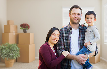 Image showing Mixed Race Chinese and Caucasian Parents and Child Inside Empty 