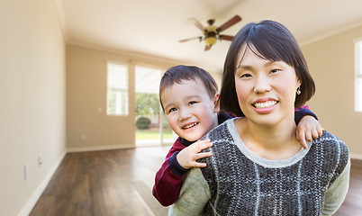 Image showing Chinese Mother and Mixed Race Child Inside Empty Room Of New Hou