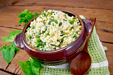 Image showing Couscous with spinach in bowl on board