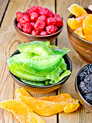 Image showing Candied pomelo and berries in bowl on wooden board