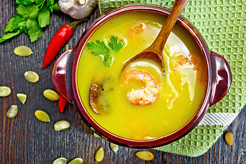 Image showing Soup-puree pumpkin with prawns and champignons on board top