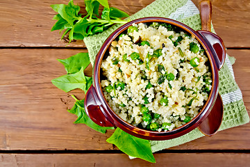 Image showing Couscous with spinach in bowl on board top