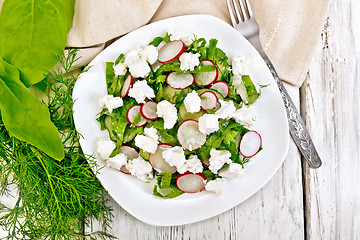 Image showing Salad with spinach and radish in plate on board top