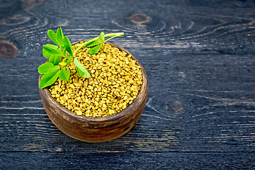 Image showing Fenugreek with leaf in clay bowl on black board