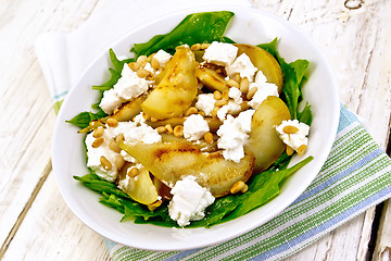 Image showing Salad from pear and spinach in dish on kitchen towel