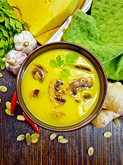 Image showing Soup-puree pumpkin with champignons on board top