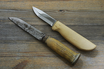 Image showing two Finnish traditional knives puukko on a wooden background