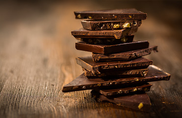 Image showing Stack chocolate on wooden table
