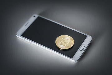 Image showing mobile phone and a bitcoin