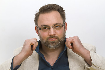 Image showing Young man arranges his shirt