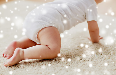 Image showing little baby in diaper crawling on floor
