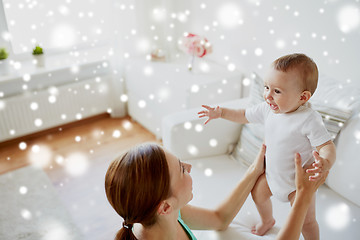 Image showing happy young mother with little baby at home