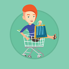 Image showing Happy woman riding by shopping trolley.