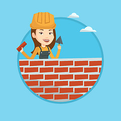 Image showing Bricklayer working with spatula and brick.