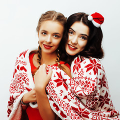 Image showing young pretty happy smiling blond and brunette woman girlfriends on christmas in santas red hat and holiday decorated plaid, lifestyle people concept