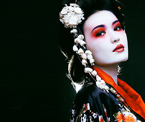 Image showing geisha in kimono on black