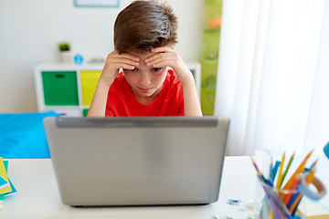 Image showing tired student boy with laptop computer at home