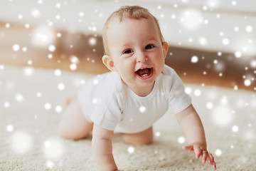 Image showing little baby in diaper crawling on floor at home