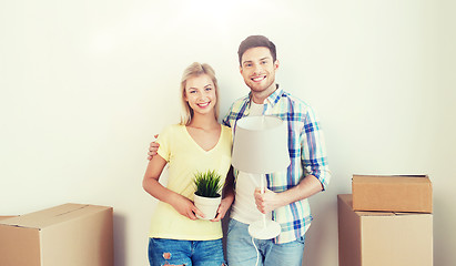 Image showing happy couple with stuff moving to new home