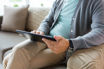 Image showing close up of senior man with tablet pc on sofa