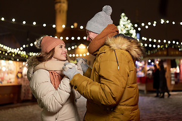 Image showing happy couple holding hands at christmas market