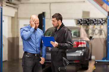 Image showing auto mechanic and customer at car shop