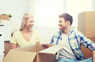 Image showing smiling couple with many boxes moving to new home