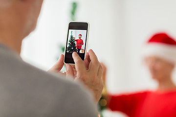 Image showing close up of senior man picturing wife at christmas