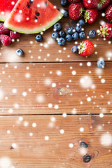 Image showing close up of fruits and berries on wooden table