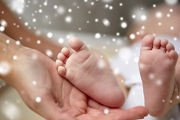 Image showing close up of newborn baby feet in mother hands