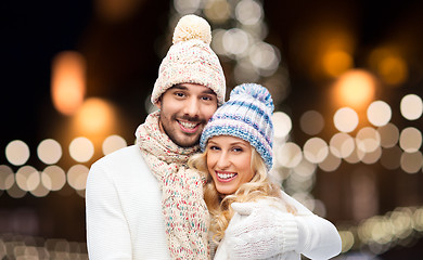 Image showing happy couple hugging over christmas lights