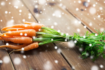 Image showing close up of carrot bunch on wooden table