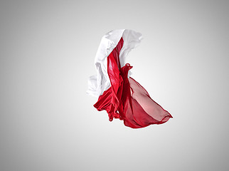 Image showing Smooth elegant transparent red and white cloth separated on gray background.