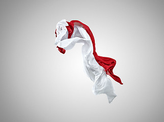 Image showing Smooth elegant transparent red and white cloth separated on gray background.