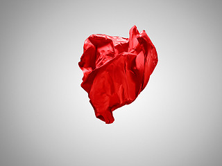 Image showing Smooth elegant transparent red cloth separated on gray background.