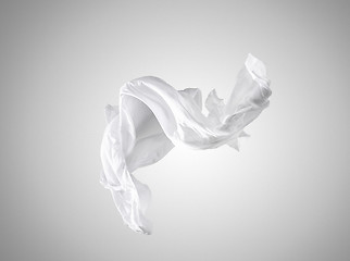 Image showing Smooth elegant transparent white cloth separated on gray background.