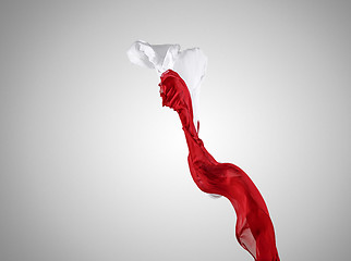 Image showing Smooth elegant transparent red and white cloth separated on gray background.