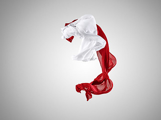 Image showing Smooth elegant transparent red and white cloth separated on gray background.