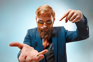 Image showing Portrait of a business man isolated on blue background.