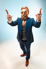 Image showing Portrait of a business man isolated on blue background.